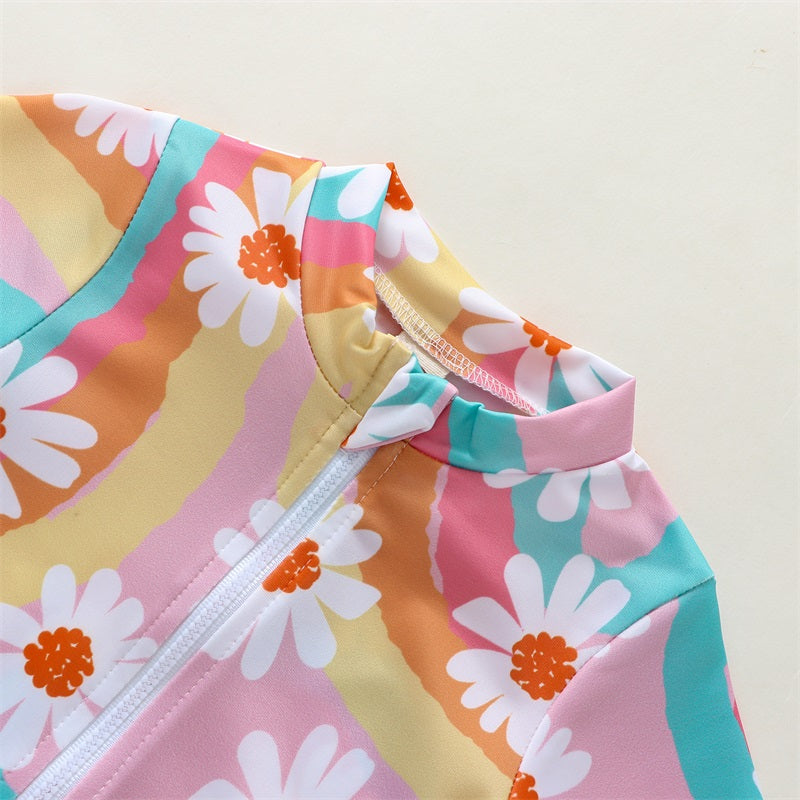 Baby girl wearing Baby Bubble UV swimsuit with long sleeves, zipper, and matching hat, designed for sun protection and comfort.