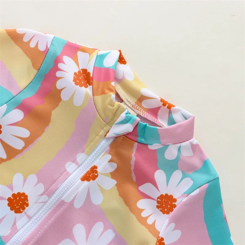 Baby Girl UV swimsuit with hat by Baby Bubble, long sleeve design with zipper, sun protection, and vibrant colors.