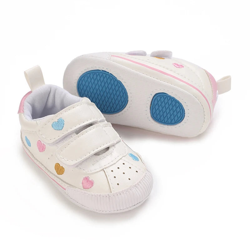 Baby girl soft sole crib shoes from Baby Bubble, designed as first walker footwear, with soft, flexible soles and cute pink accents.