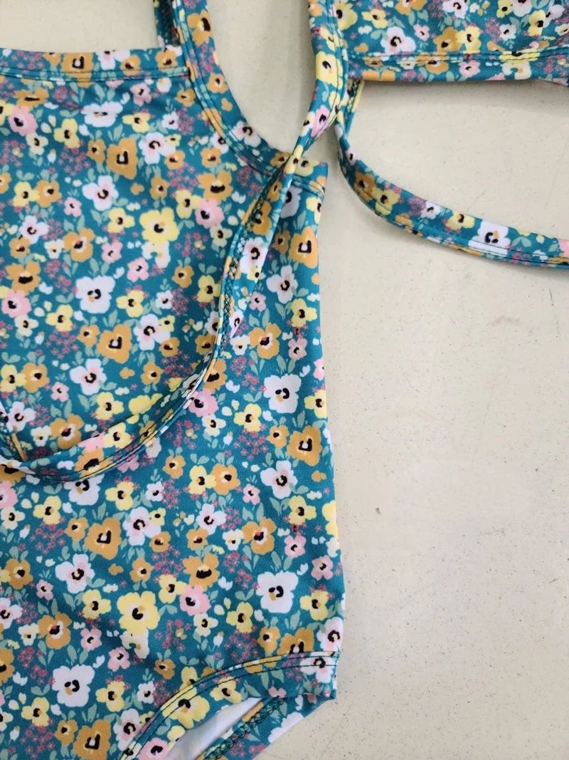 Baby girl swimwear set by Baby Bubble featuring a one-piece swimsuit and matching sun hat, perfect for summer beach outings.