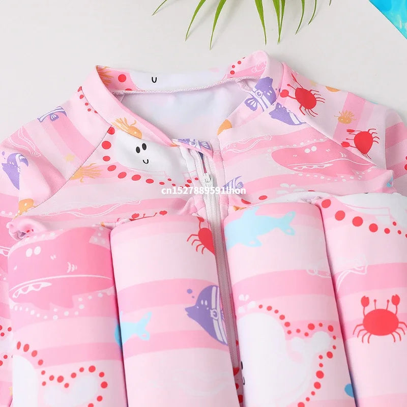 Children's buoyancy swimsuit by Baby Bubble with colorful cartoon print, designed for safety and fun in the water.