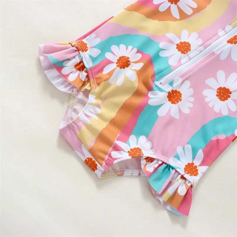 Baby Girl UV swimsuit with long sleeves and matching hat, featuring a zipper closure, by Baby Bubble, ideal for sun protection.