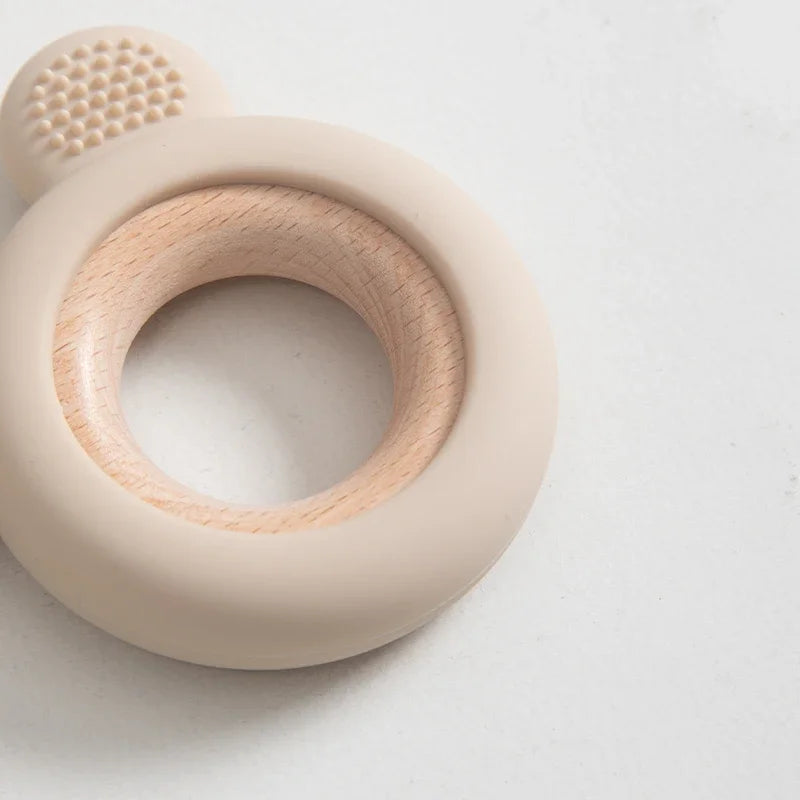 Baby Bubble silicone wood teether ring, safe soothing chew toy for babies, featuring a natural wood and silicone design.