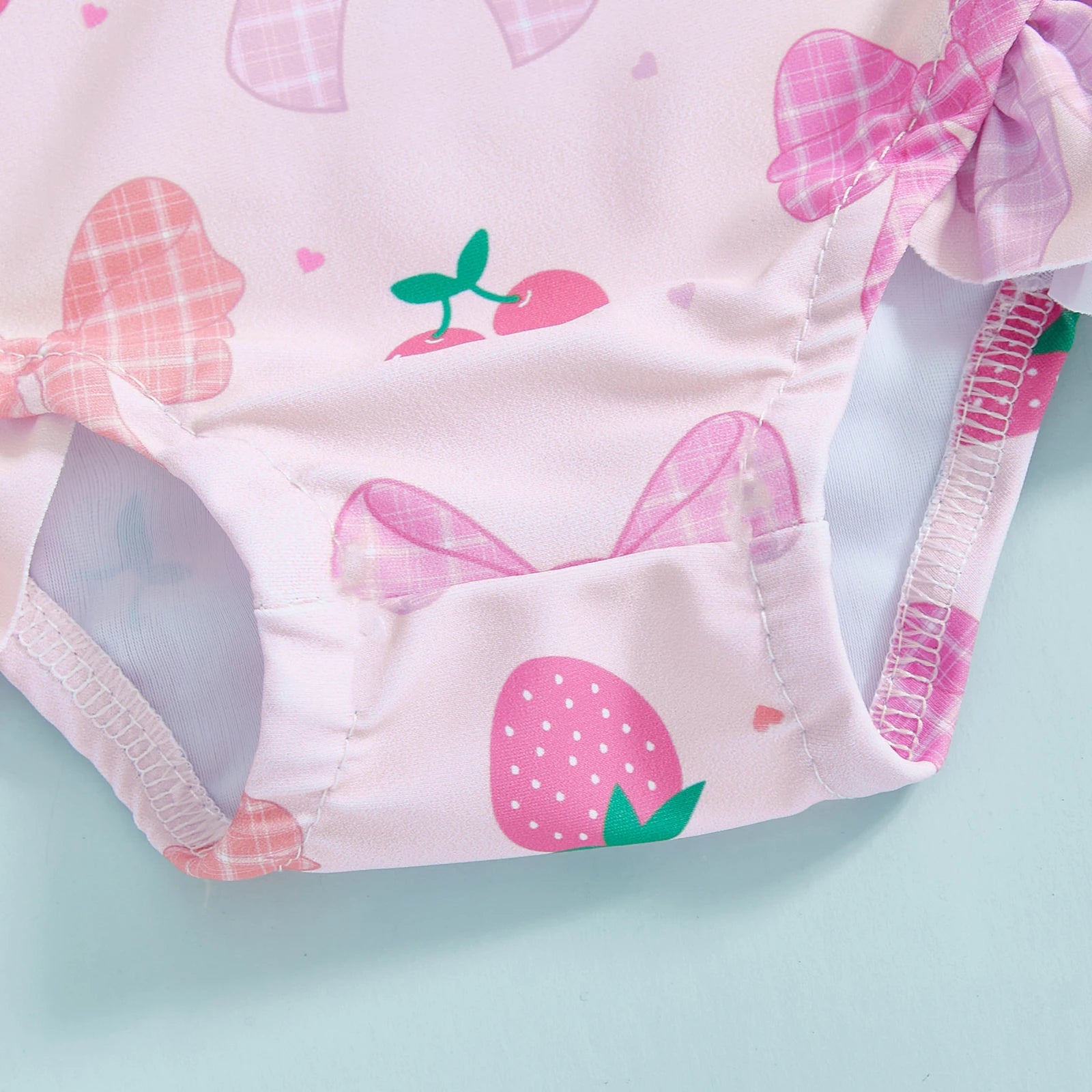 Baby girls floral rash guard with hat from Baby Bubble, featuring a zip-up design and colorful floral pattern for sun protection.