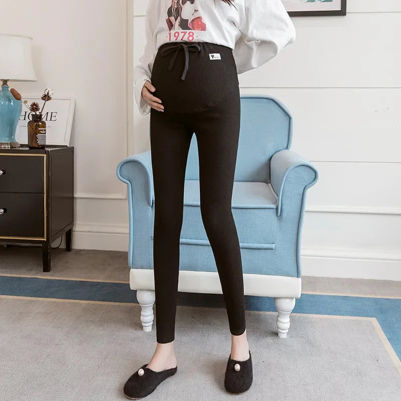 Adjustable maternity pants by Baby Bubble with soft high waist and comfortable fit, shown in a relaxed pose.