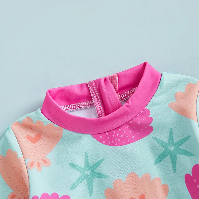 Baby girls rash guard swimsuit with shell print UV cover by Baby Bubble, designed for sun protection during swimming.