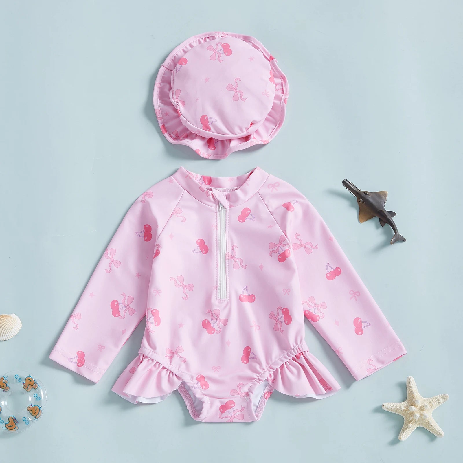 Baby girl wearing floral rash guard with hat, Baby Bubble zip-up swimwear for sun protection, outdoors on sunny day