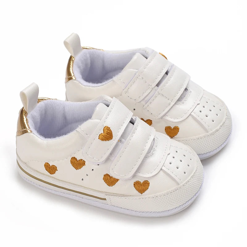 Baby girl soft sole crib shoes by Baby Bubble, first walker style with pink and white details for infants.