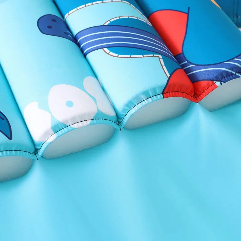 Kids buoyancy swimsuit by Baby Bubble featuring a colorful cartoon float design, designed for safe swimming and water play.