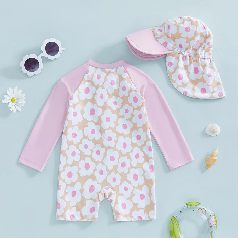 Baby girl wearing a floral and flamingo print rash guard set by Baby Bubble, showing colorful, lightweight swimwear for children.
