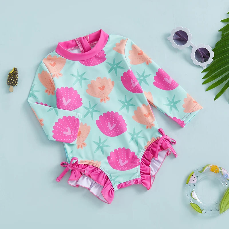 Baby girls rash guard swimsuit with shell print from Baby Bubble, featuring UV protection and comfortable fit for swimming.