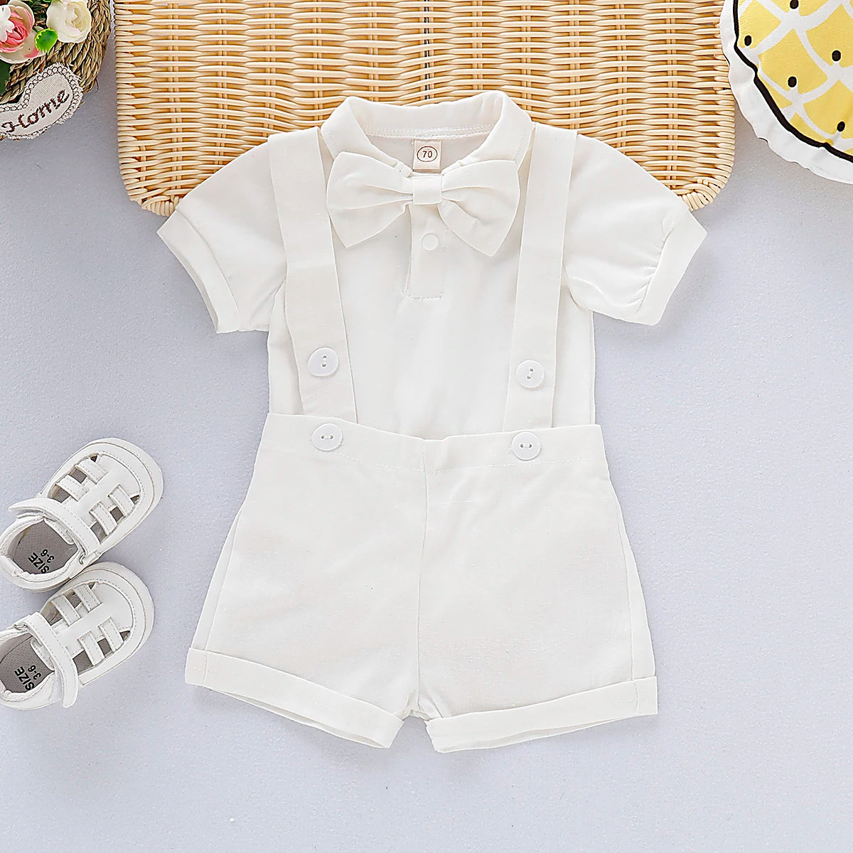 Newborn boy in Baby Bubble gentleman bowtie romper, summer set for ages 0-24 months, featuring a stylish bowtie and romper outfit.