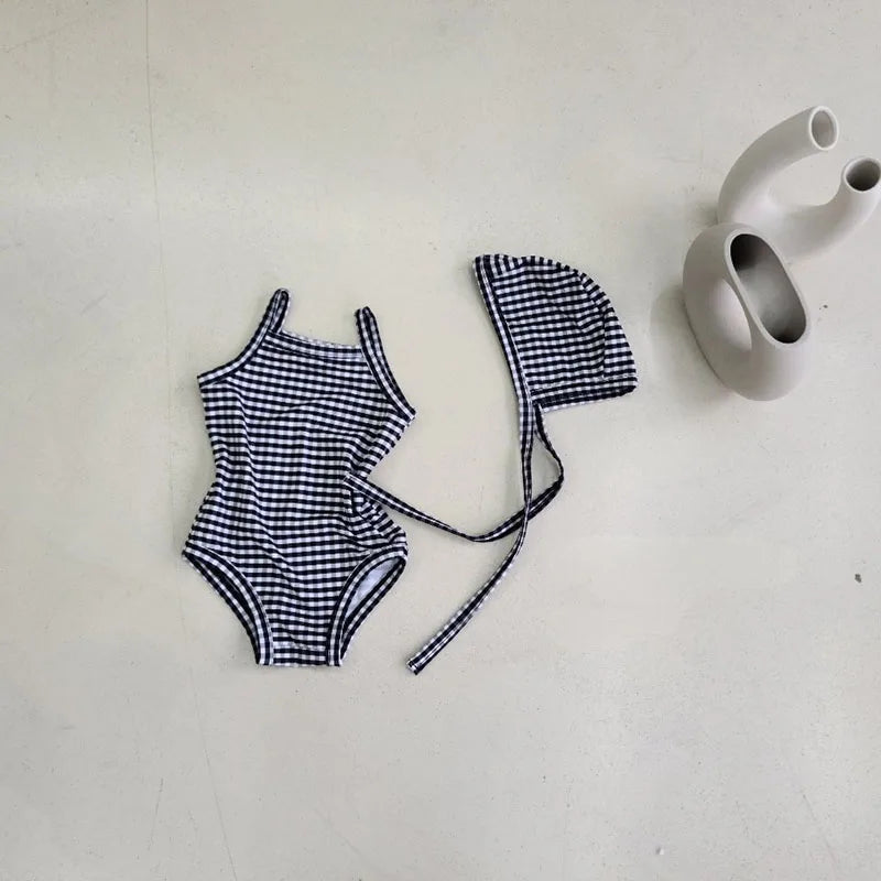 Baby girl swimwear set with one-piece swimsuit and sun hat, featuring colorful patterns and soft fabric from Baby Bubble.