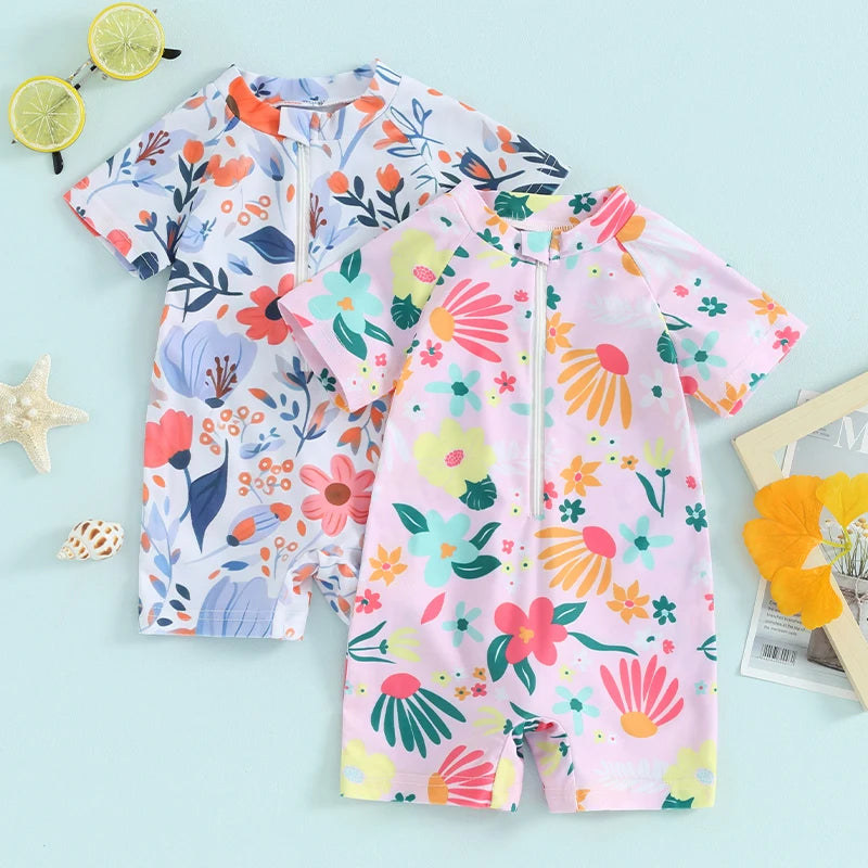Baby girls floral rash guard romper by Baby Bubble, featuring a zip-up design and colorful floral pattern for sun protection.