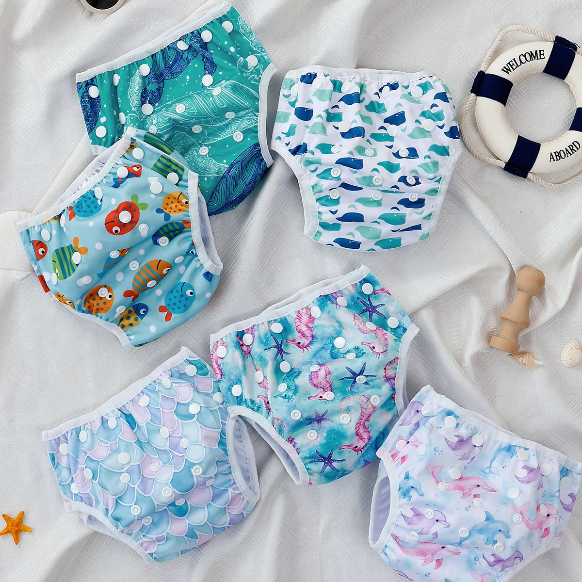 Baby Bubble washable baby swim diapers with adjustable fit, shown in blue and orange, featuring soft waterproof material and elastic waistband.