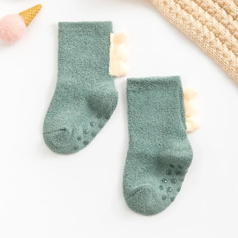 Soft, warm baby dinosaur socks by Baby Bubble featuring colorful dinosaur patterns for infants' comfort.