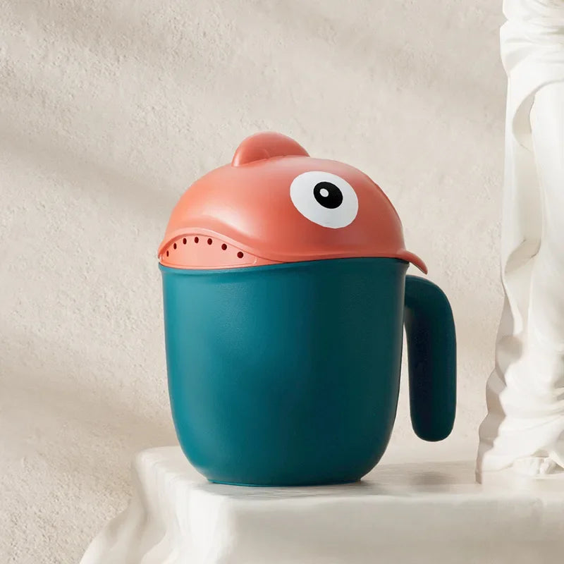 Baby Shark rinse cup by Baby Bubble, tear-free hair washing helper with colorful shark design for gentle rinsing.