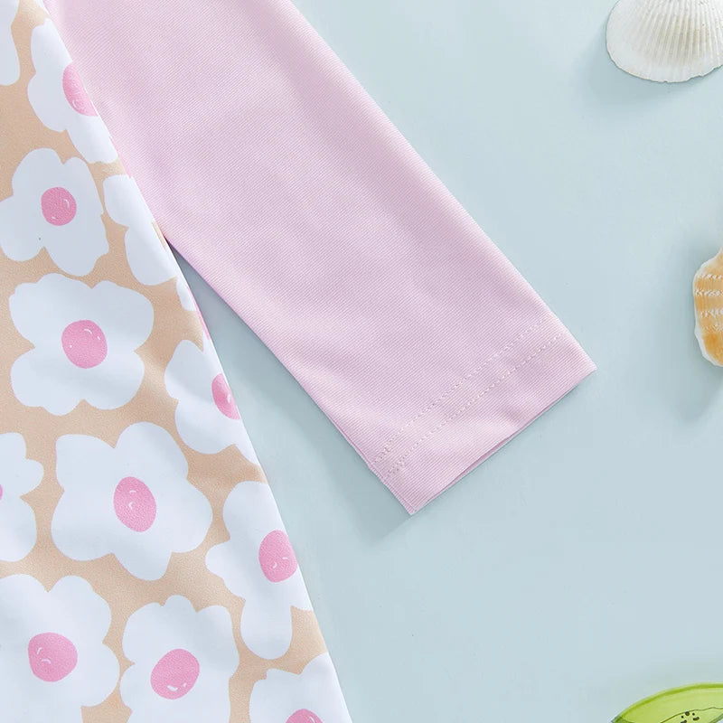 Baby girl rash guard set by Baby Bubble with floral and flamingo print, featuring long sleeves and matching swimwear for summer.