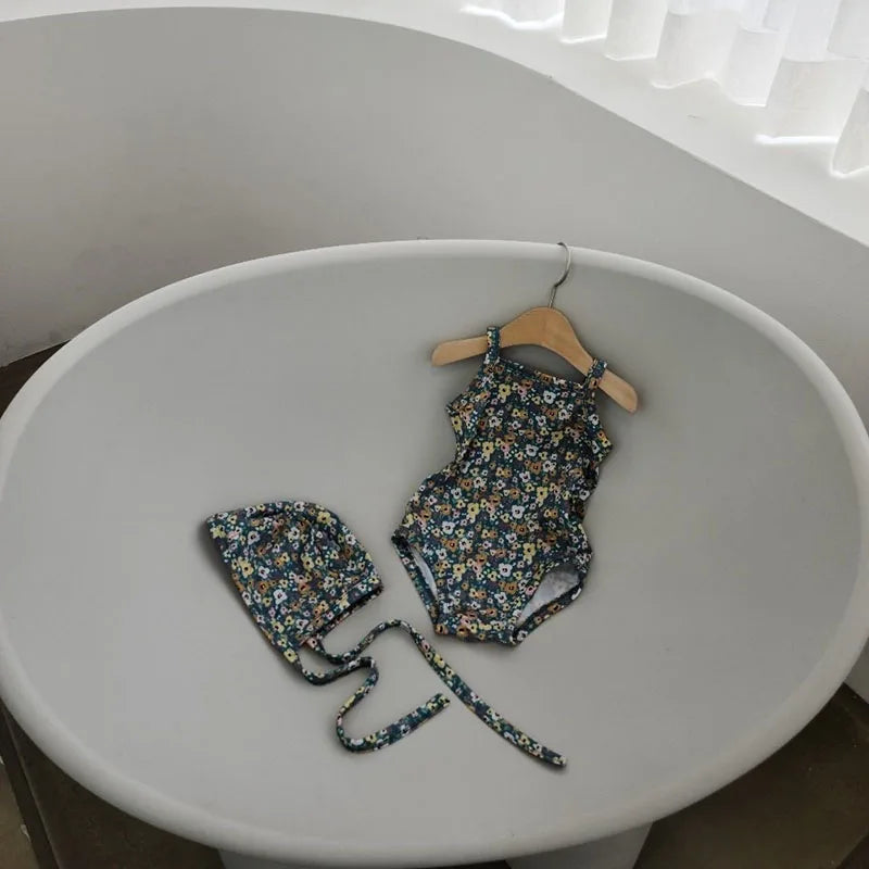 Baby Girl swimwear set with one-piece swimsuit and sun hat, featuring colorful patterns and sun protection details.
