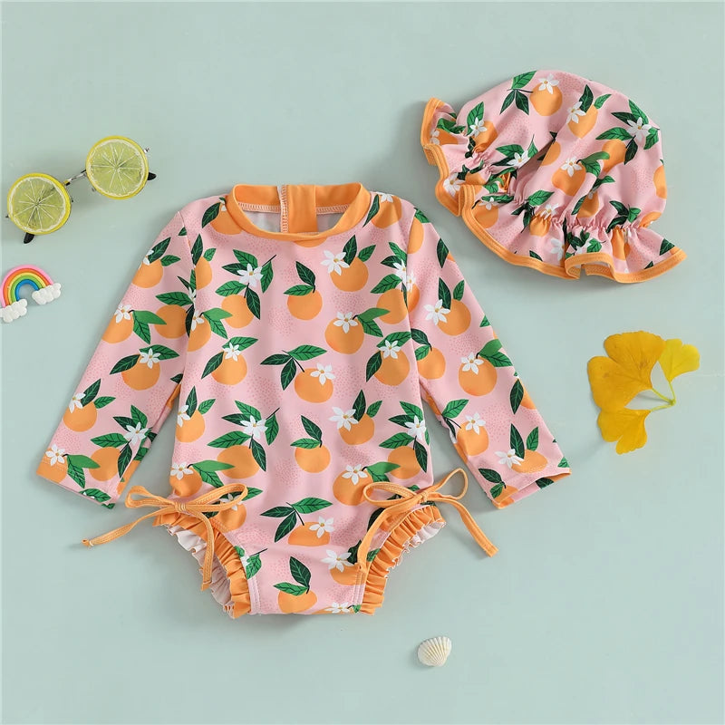 Baby girl wearing Baby Bubble rash guard swimsuit and matching swim cap, perfect for sun protection during swimming.